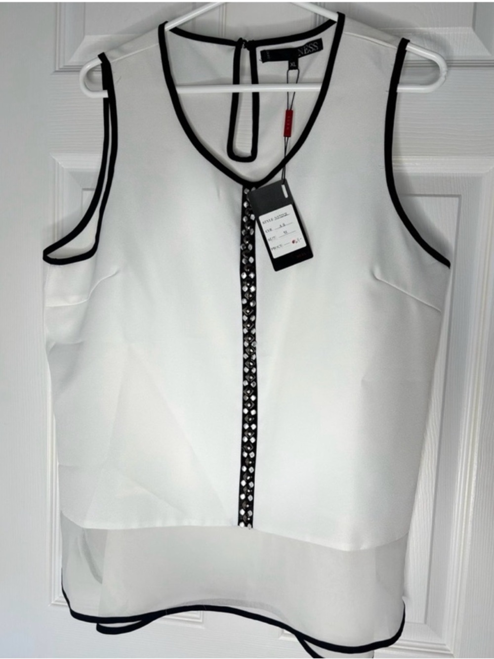 Sleeveless White Blouse with Black Trim and Embellished Placket